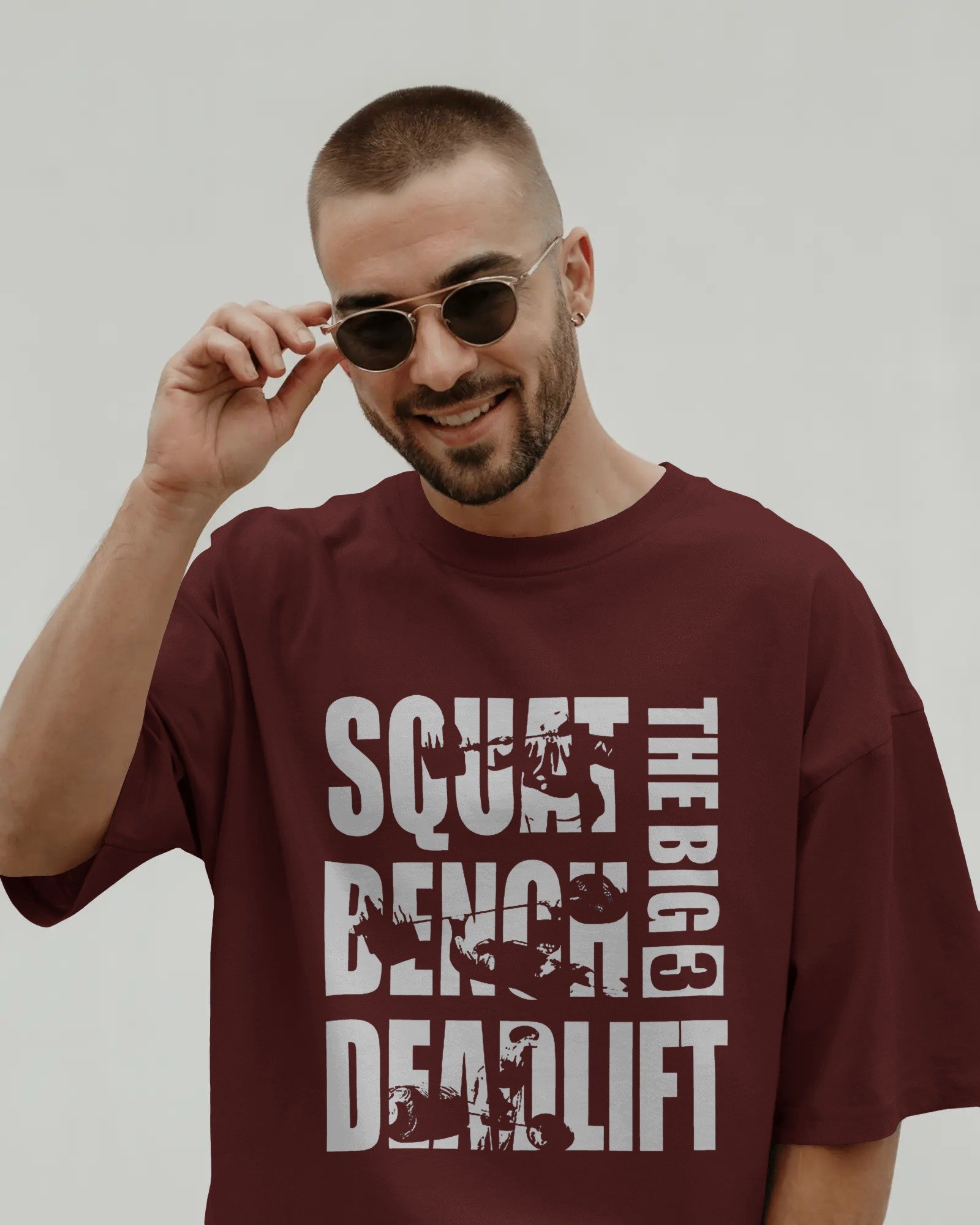 smiling-male-model-in-t-shirt-mockup-adjusting-sunglasses-on-clean-background-modern-stylish-look-02103